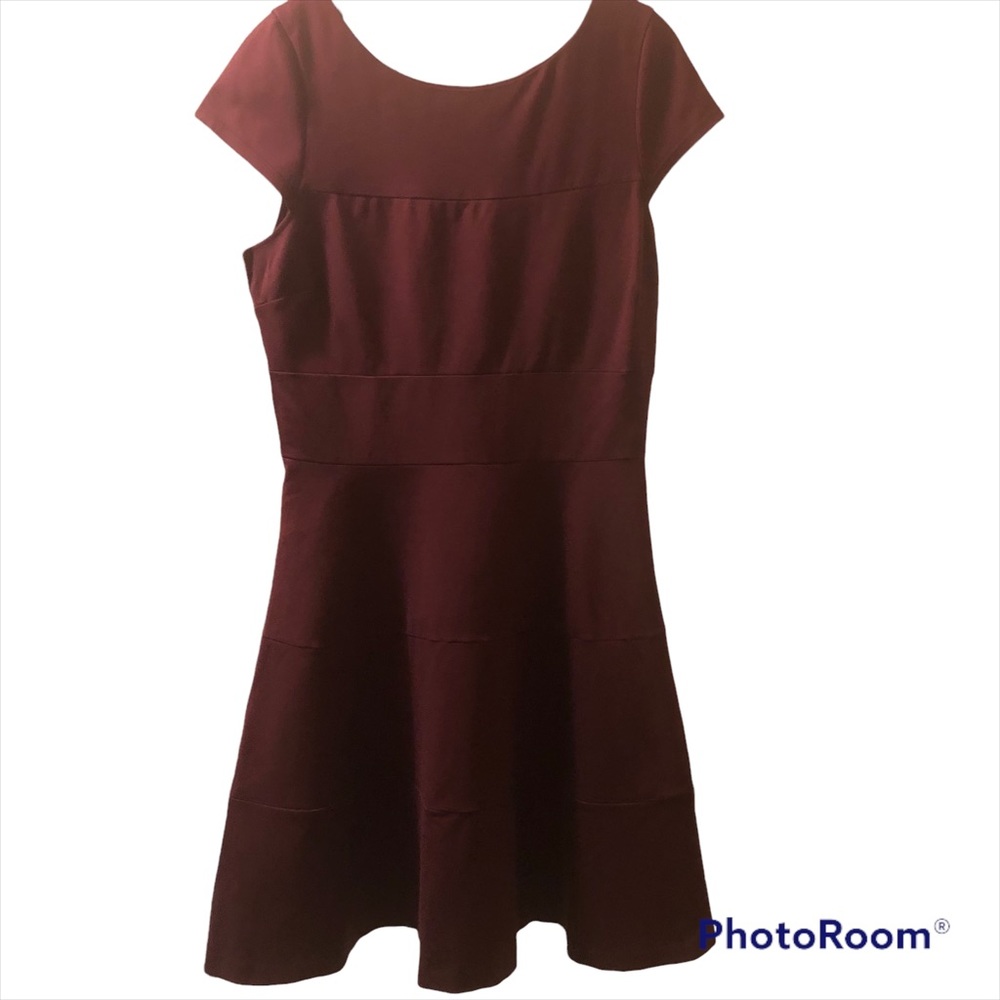 Burgundy midi dress with skirt that flares out to A line shape.